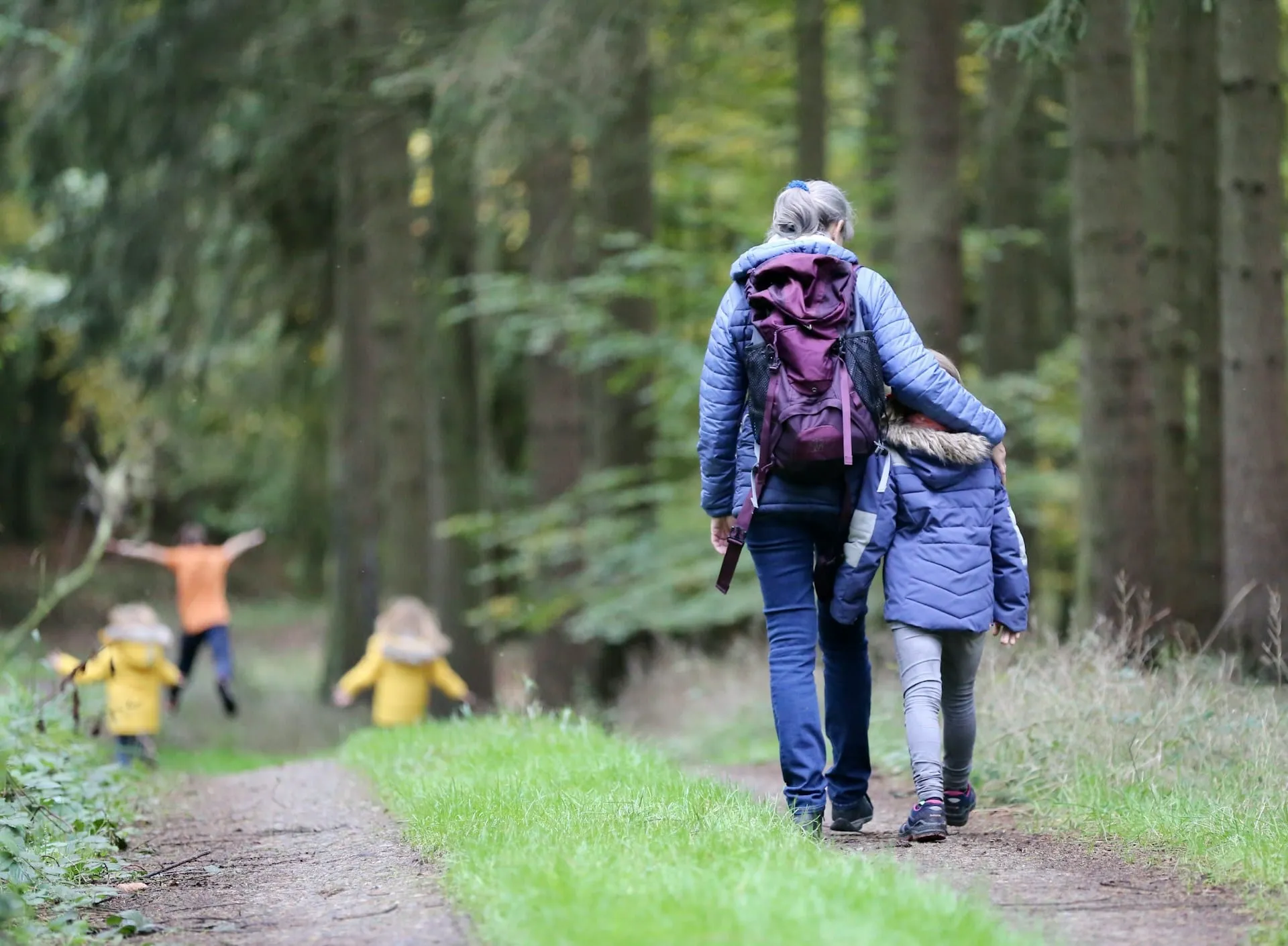 A family walking together along a forest path