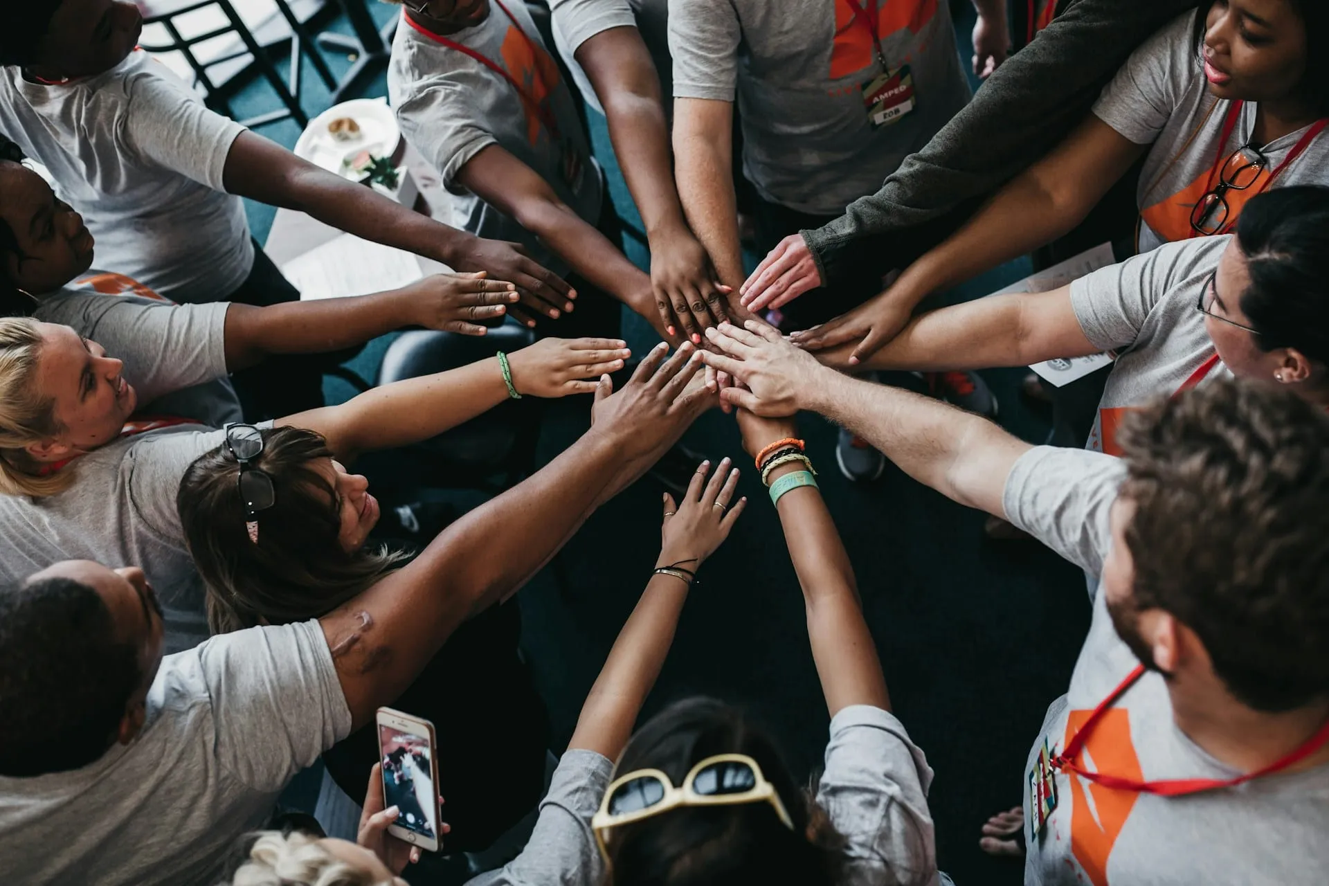 A circle of people joining hands in the middle