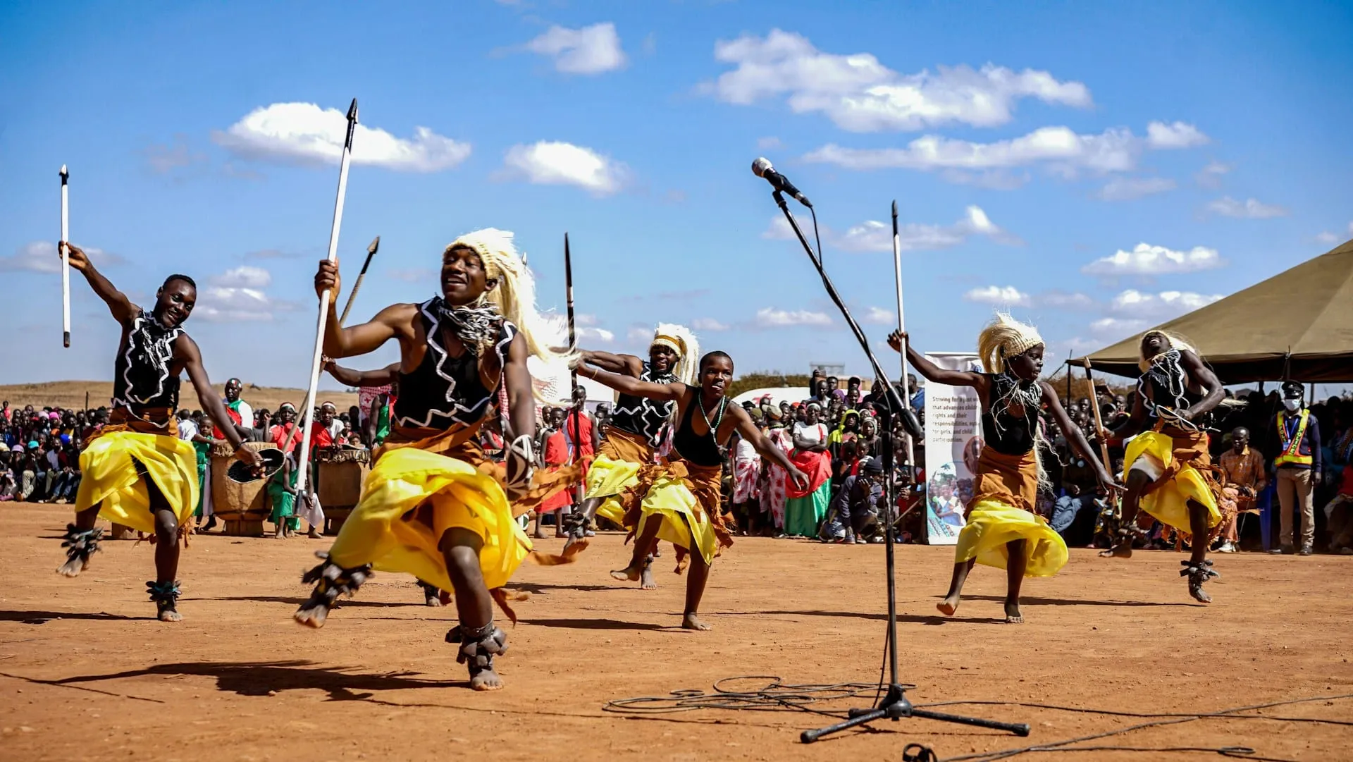 Dancers in traditional dress performing at an outdoor celebration